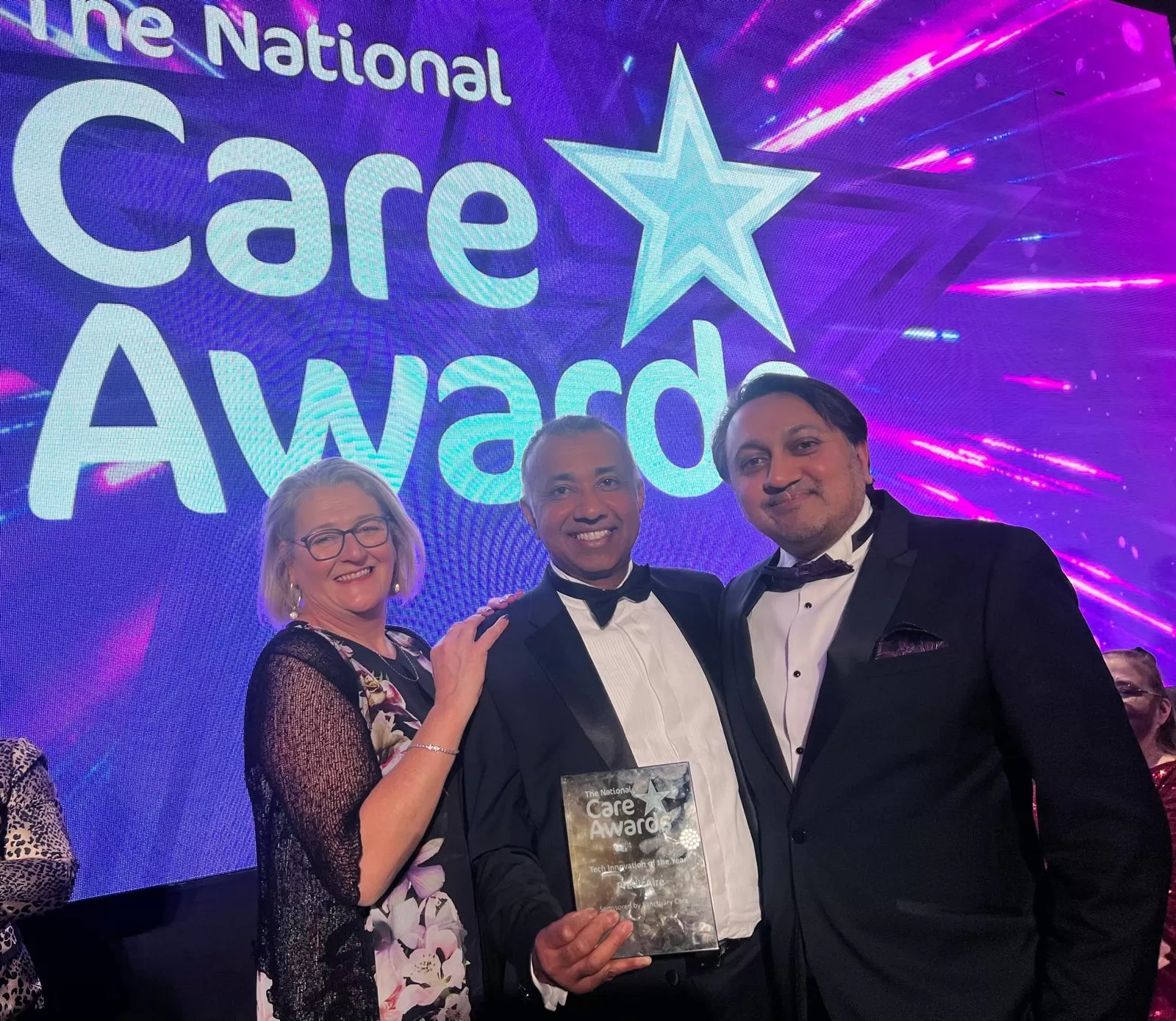 Michelle Cox, Ketan Shah and Vinay Patel collecting the National Care Awards 2024 trophy.